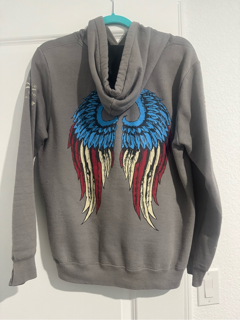 Grunt Style Gray Hoodie with Blue, Red and Cream Wing Graphic